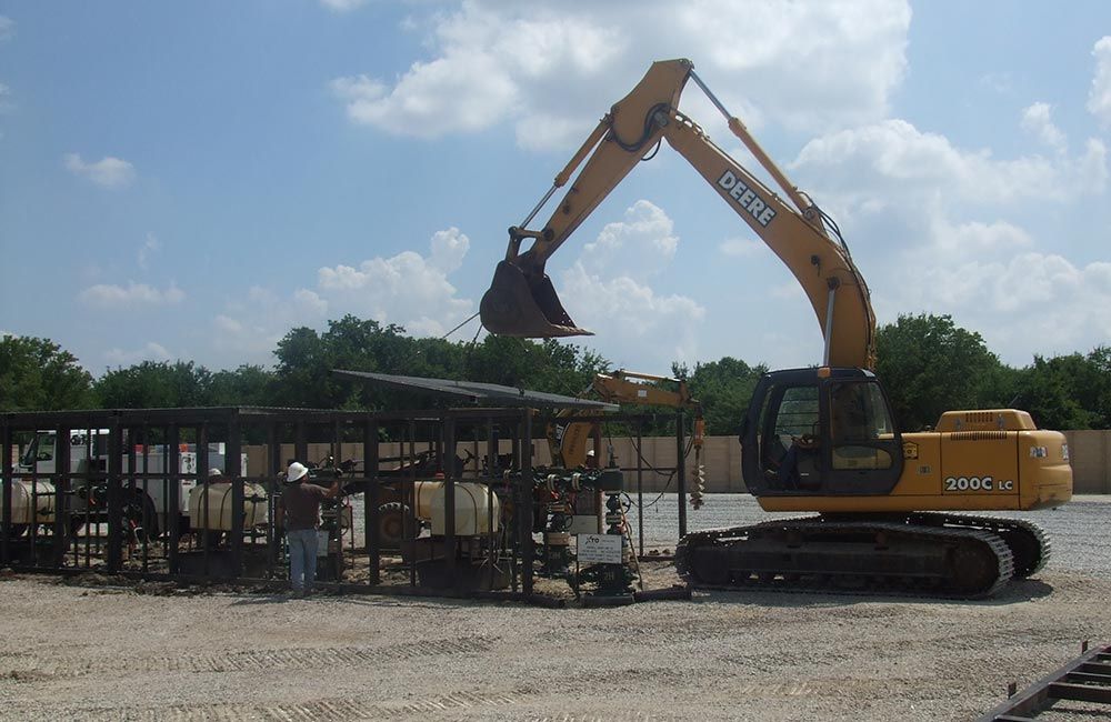 Wellhead enclosure placement with front end loader